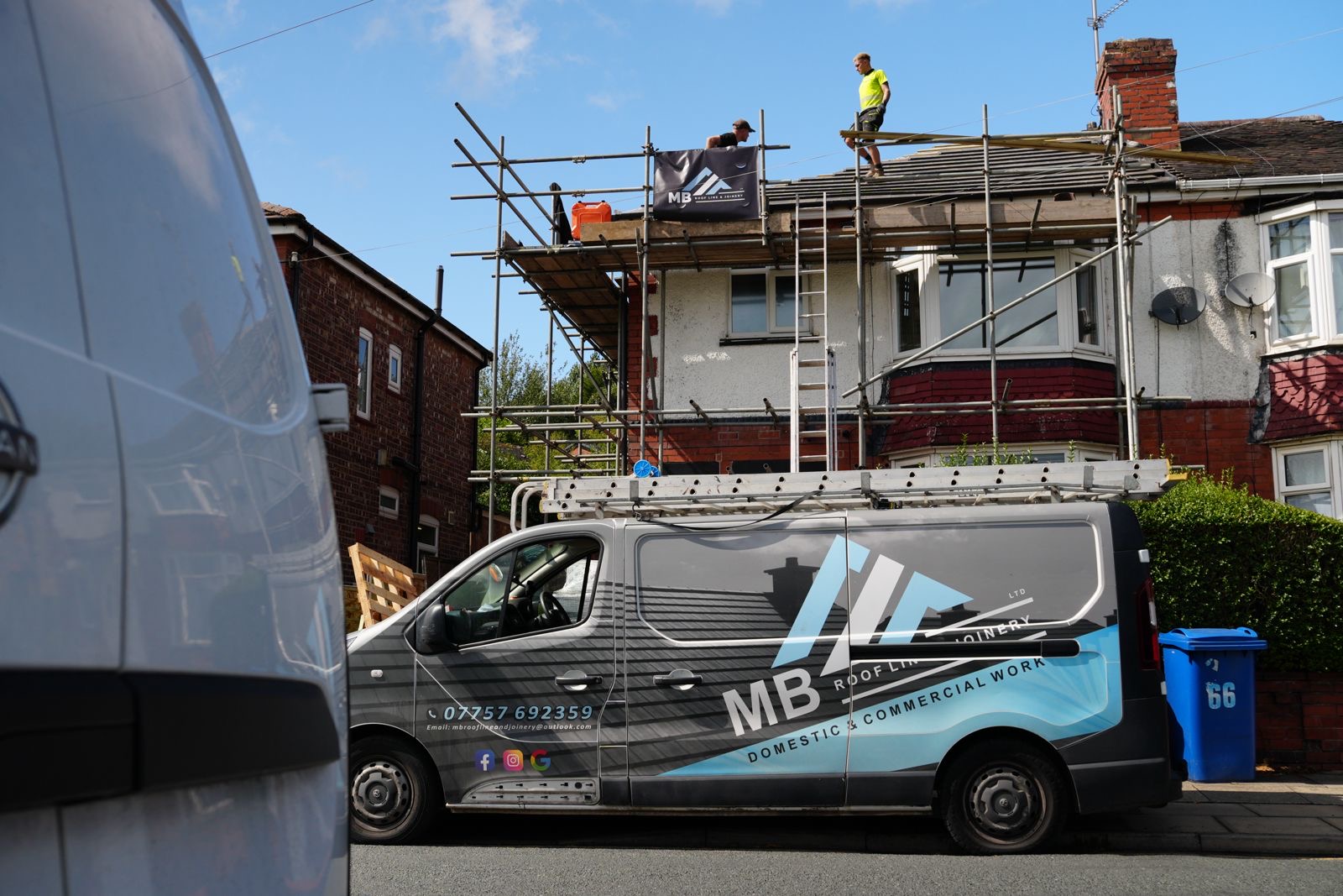 MB Roofline van parked outside a house while the team works on the scaffolded roof