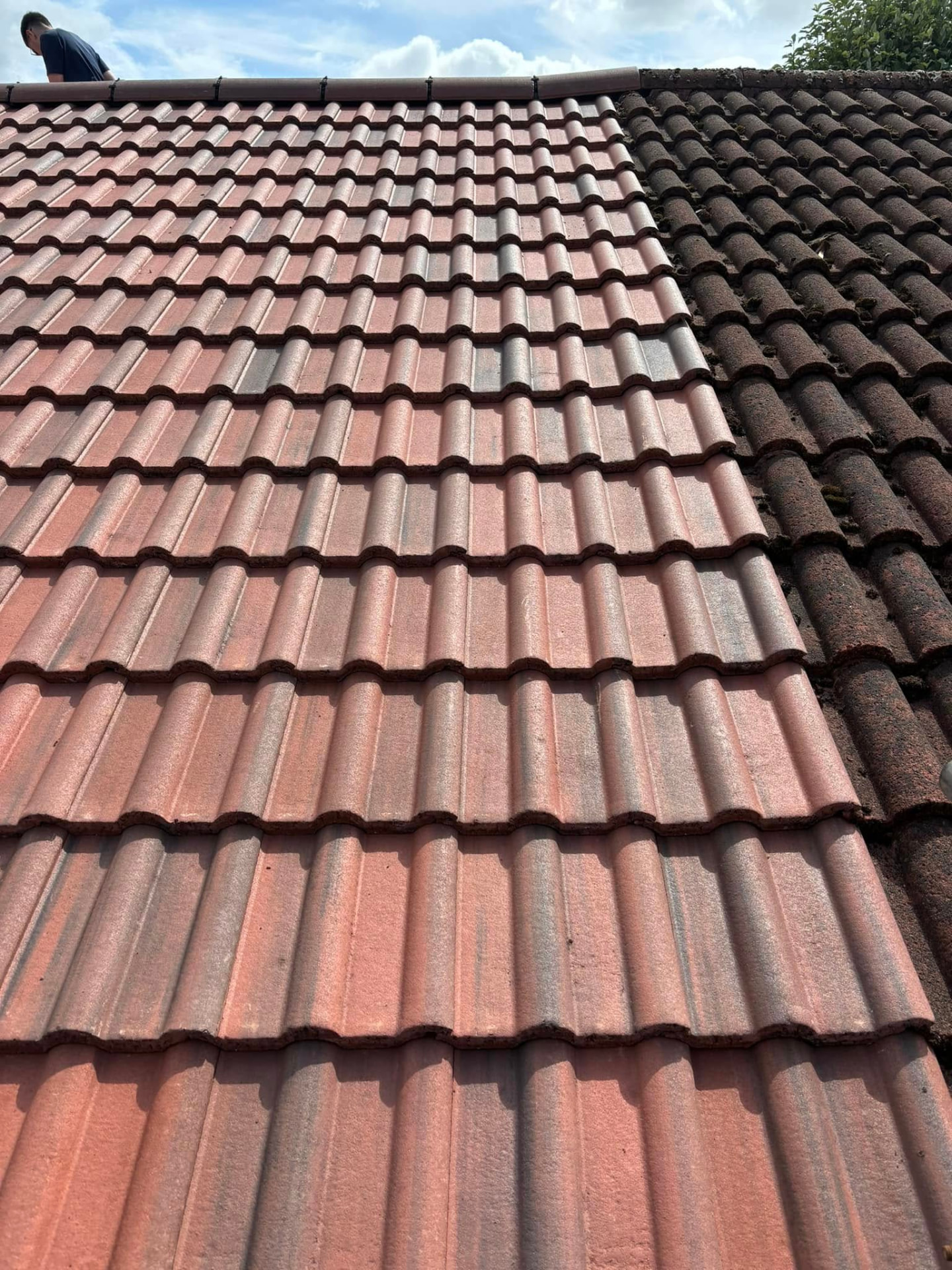 Re-tiled pitched roof with new ridge tiles in place